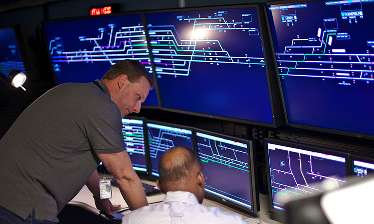 Wabtec workers looking at a screen