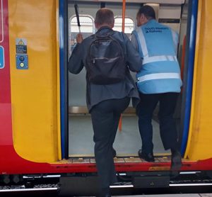 Blind man walking onto a SWR train