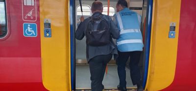 Blind man walking onto a SWR train