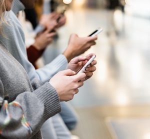 Young people using mobile phones in underground