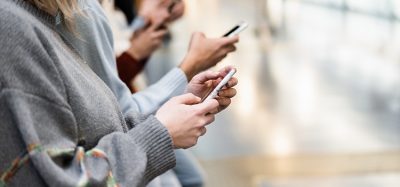 Young people using mobile phones in underground