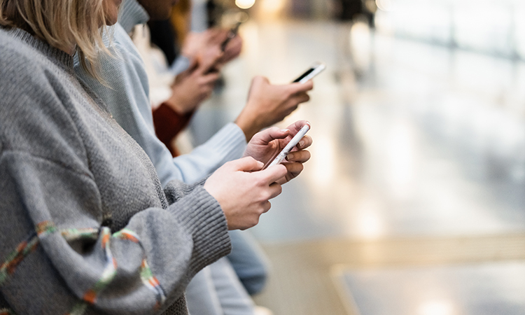 Young people using mobile phones in underground