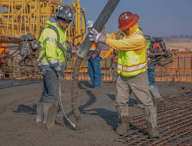 Crew pouring concrete on high speed rail project