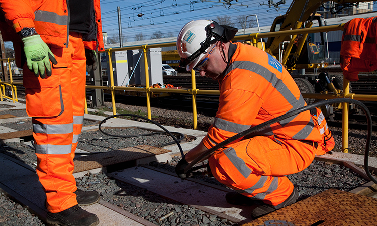 Engineer fitting new cables as part of the East Coast Digital Programme
