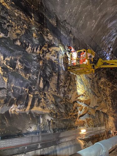 Engineers examining stone tunnel walls inside Liverpool High Neck tunnel