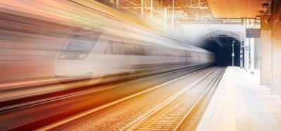 stylised image of a train travelling through a tunnel, featuring warm colours that indicate the dawn of a new day