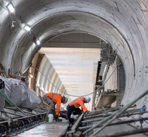 Australian rail workers helping to construct tunnel infrastructure.