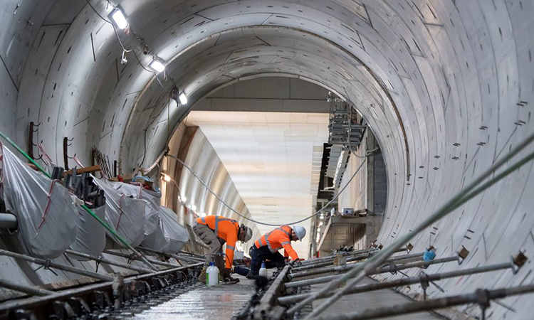 Australian rail workers helping to construct tunnel infrastructure.