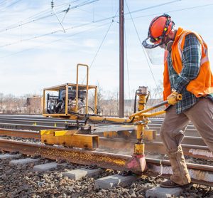 Man working on the infrastructure of the 16-mile segment of track between New Brunswick and South Brunswick