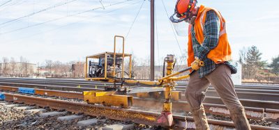 Man working on the infrastructure of the 16-mile segment of track between New Brunswick and South Brunswick