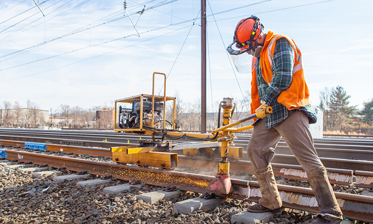 Man working on the infrastructure of the 16-mile segment of track between New Brunswick and South Brunswick