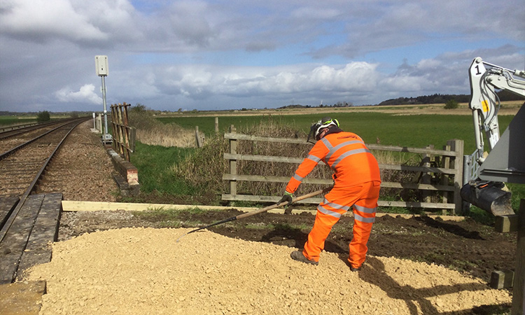 Installing a new, less bumpy approach to a rural level crossing around Somerleyton