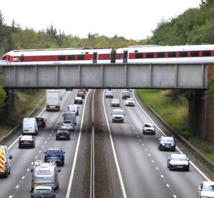 LNER train travelling over a motorway