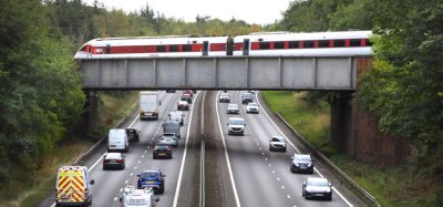 LNER train travelling over a motorway