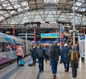 Liverpool station with passengers walking toward a train during November 2021