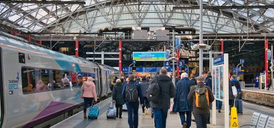 Liverpool station with passengers walking toward a train during November 2021