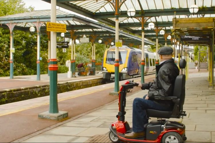 Mobility scooter user on platform.