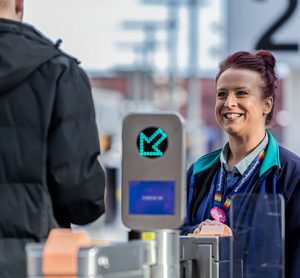 A northern employee engaging with a passenger