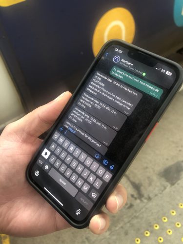 This image shows the new whatsapp service being used on a phone next to a Northern train