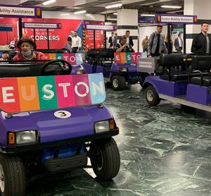 Two passenger assistance buggies that have been replaced by newer, electric machines.