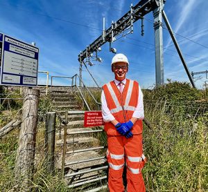 Rob McIntosh, Managing Director for Network Rail's Eastern region, next to the first new electric overhead wires on a mainline in Yorkshire for 25 years.