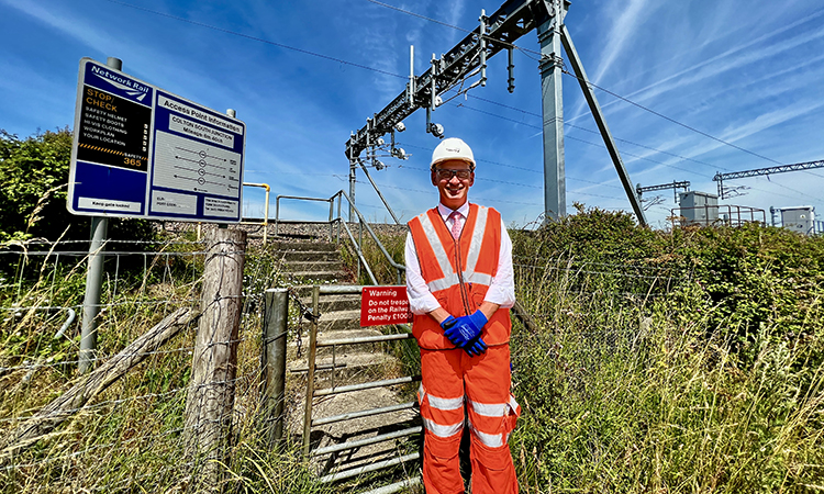 Rob McIntosh, Managing Director for Network Rail's Eastern region, next to the first new electric overhead wires on a mainline in Yorkshire for 25 years.