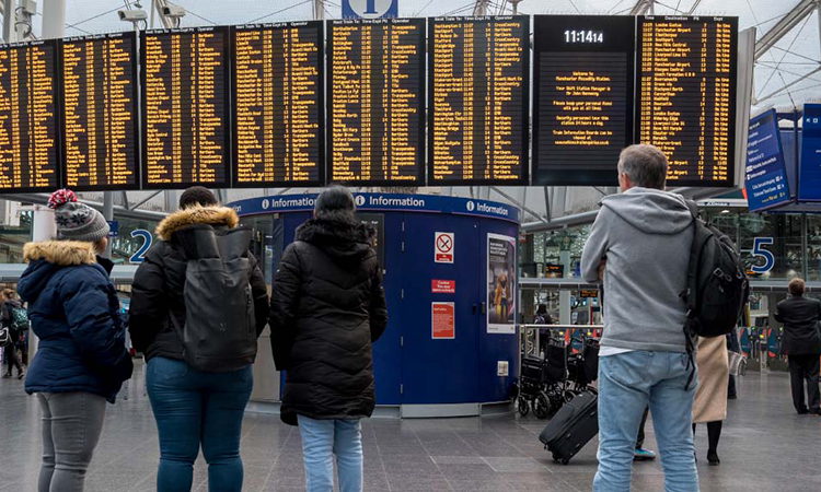 Passengers looking at a timetable