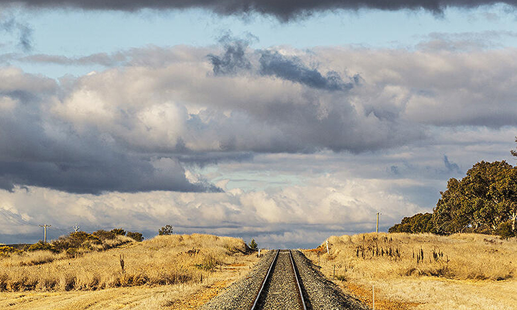 Vast landscape with rail tracks running through the foreground