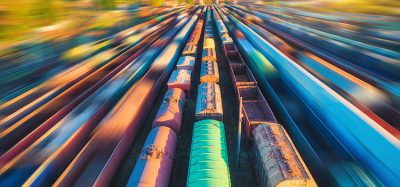 Aerial view of colorful freight trains at sunset.