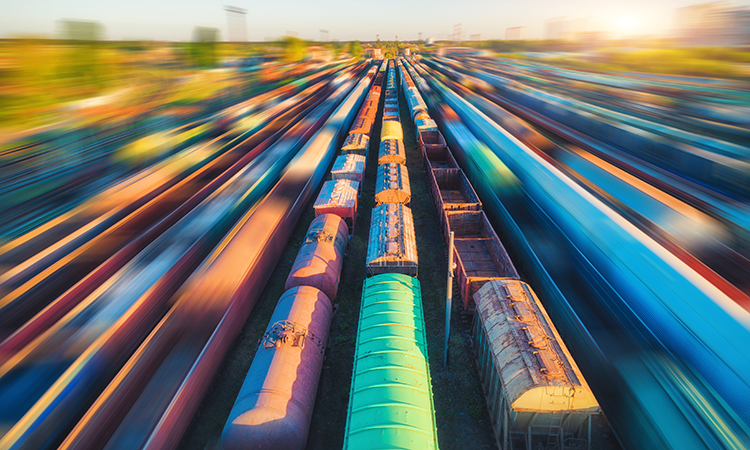 Aerial view of colorful freight trains at sunset.