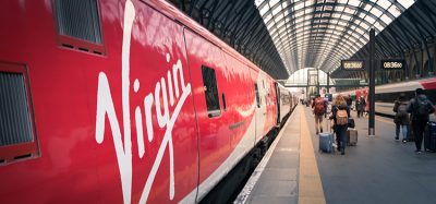 Passengers walk on platform of London King's Cross station where is a Central London railway terminus on the northern edge of the city