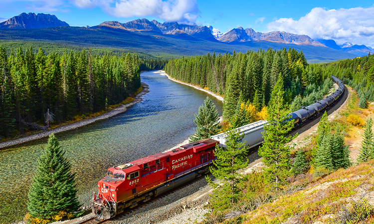 Long freight train Canadian Pacific Railway (CPR) moving along Bow river in Canadian Rockies ,Banff National Park, Canadian Rockies,Canada.