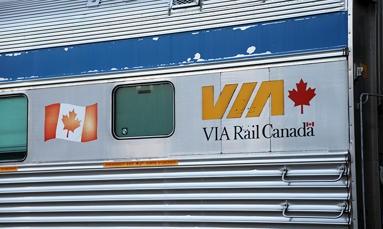VIA Rail train pulling into a station in Canada