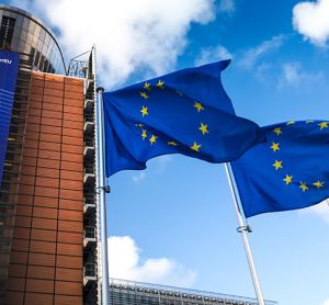 European Union flags waving in wind in front of European Commission building. Brussels, Belgium.