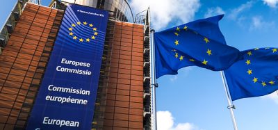 European Union flags waving in wind in front of European Commission building. Brussels, Belgium.