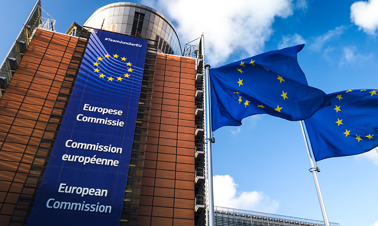 European Union flags waving in wind in front of European Commission building. Brussels, Belgium.