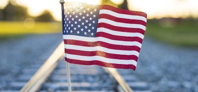 A closeup shot of the flag of the USA on the train rails