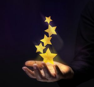 Golden stars above a hand indicating success.