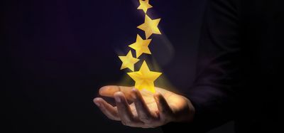 Golden stars above a hand indicating success.