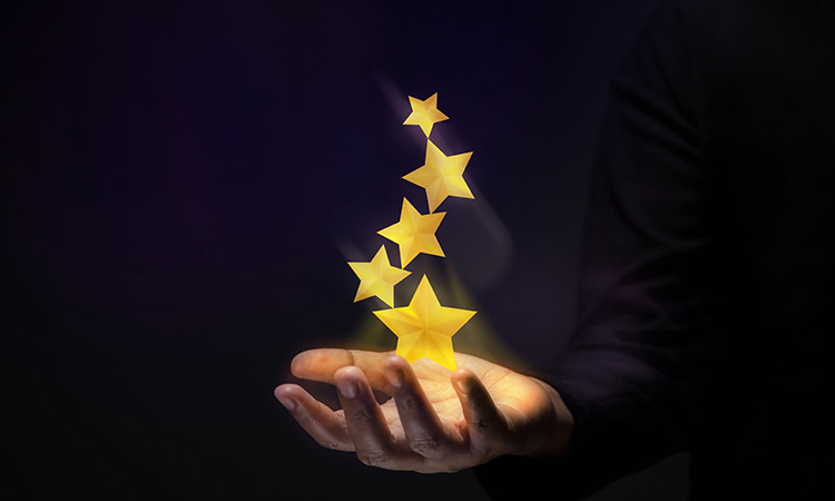 Golden stars above a hand indicating success.