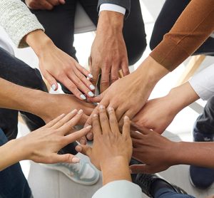 Narrow banner of multiracial people stack hands