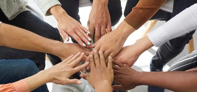 Narrow banner of multiracial people stack hands