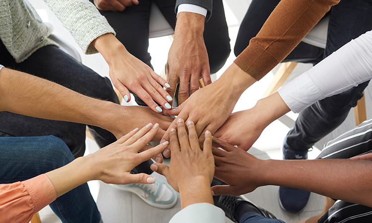 Narrow banner of multiracial people stack hands