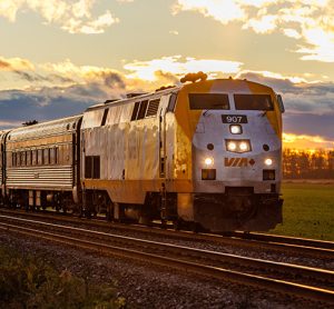 A VIA Rail train travels eastbound to Montreal during sunset