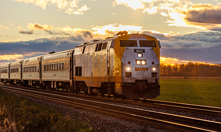 A VIA Rail train travels eastbound to Montreal during sunset