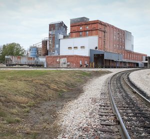 An industrial building along the railroad tracks