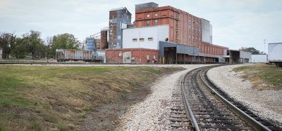 An industrial building along the railroad tracks