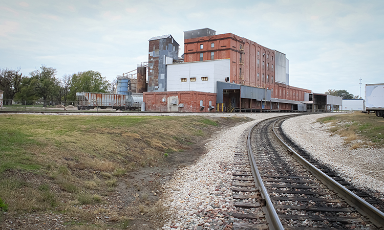 An industrial building along the railroad tracks