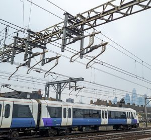 Train running on electric with miles of power lines overhead. A cleaner and more environmentally friendly way to power transport.