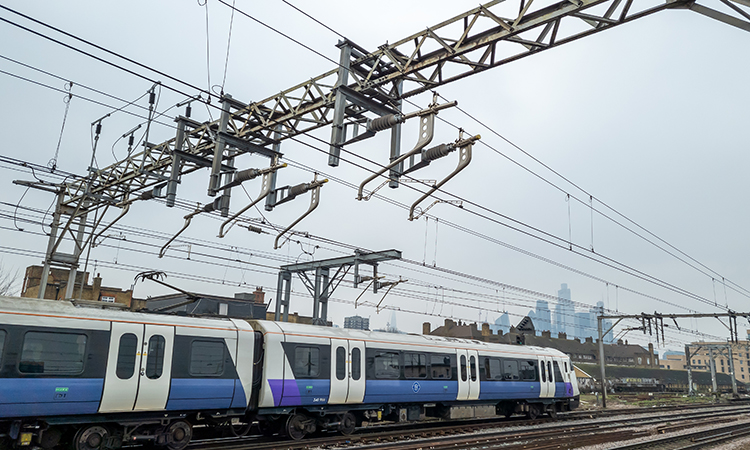 Train running on electric with miles of power lines overhead. A cleaner and more environmentally friendly way to power transport.